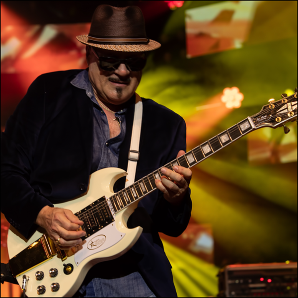 Latin Rock Band guitarist performing a solo onstage | Altus Entertainment